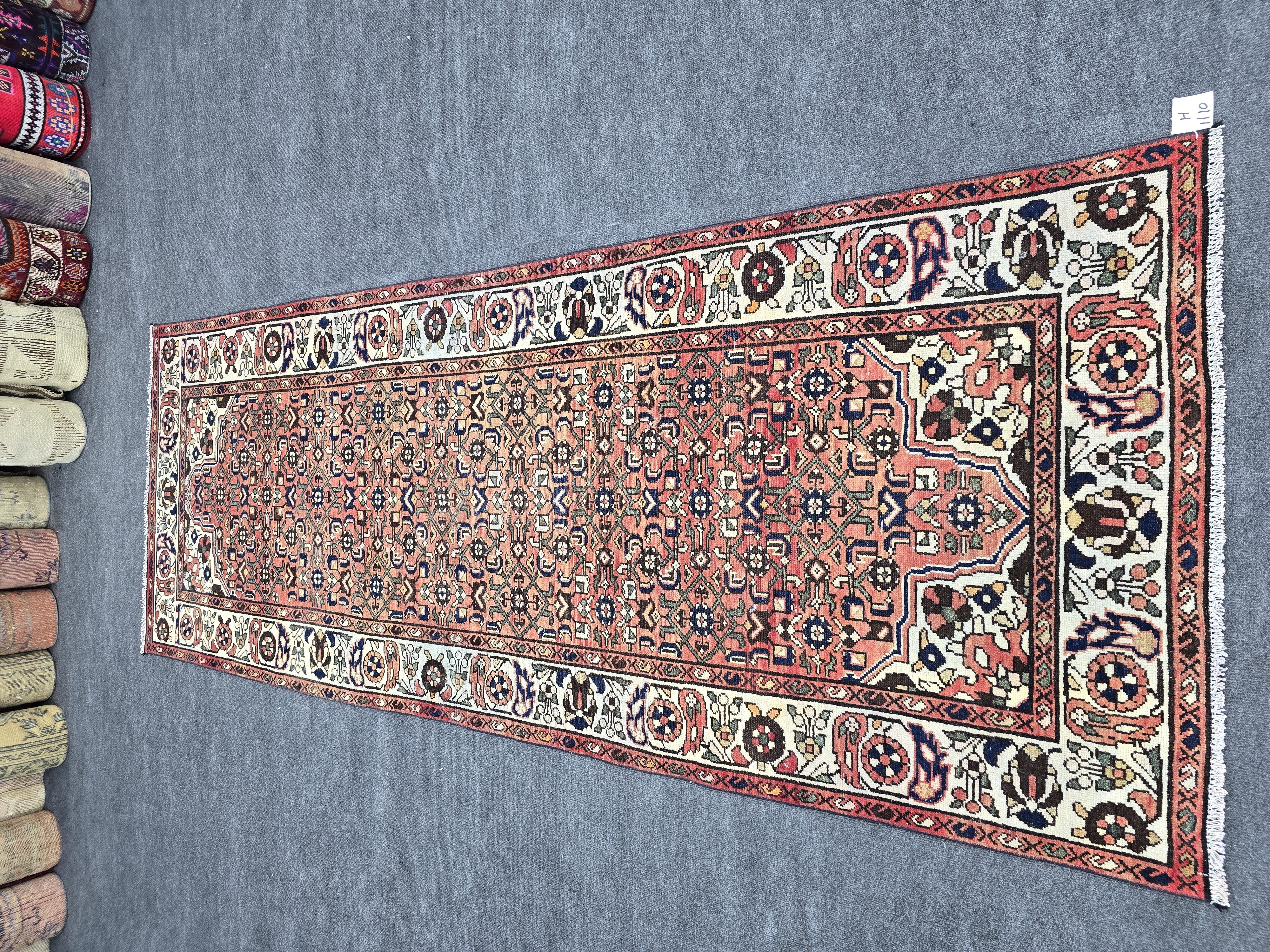Vintage 3x10 feet Turkish runner rug in terracotta red and beige with geometric patterns, ideal for hallways and entryways. Hand-knotted wool rug.