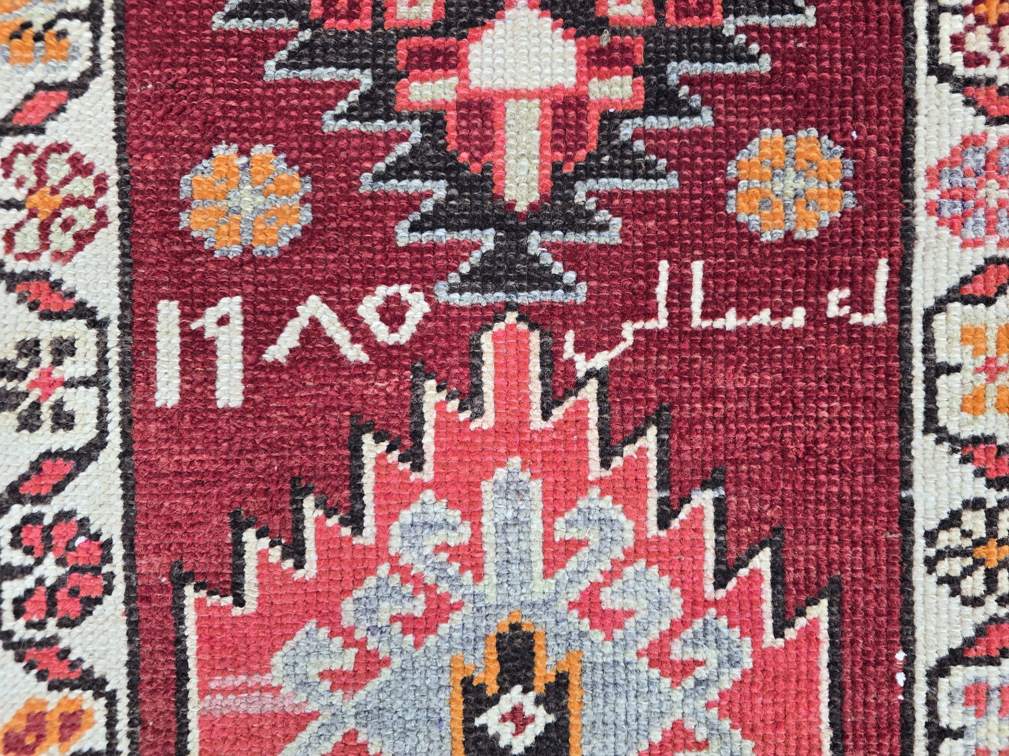 Long vintage hand-knotted Anatolian runner rug with a vibrant red field, featuring geometric tribal motifs in beige, orange, black, and pink, perfect for a hallway or kitchen.